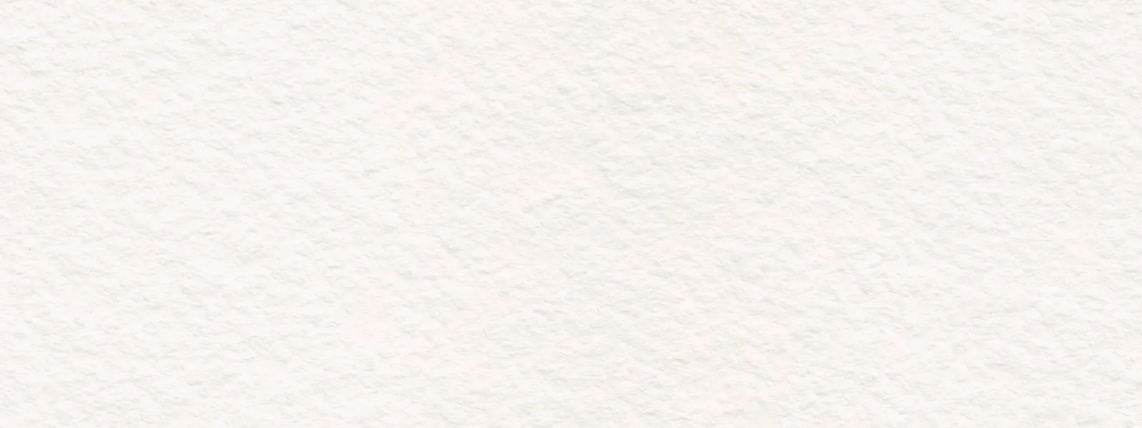 A soft, warm-neutral textured surface in natural light